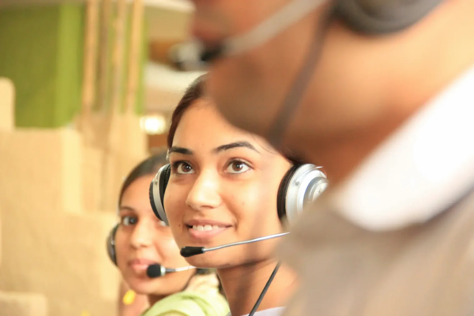 Customer Service representatives with telephone headsets