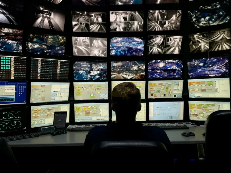 Security officer monitoring a bank of CCTV monitors